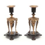 A PAIR OF REGENCY BRONZE AND ORMOLU CANDLESTICKS / INCENSE BURNERS with removable scones and mask