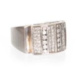 A LARGE GENTLEMANS 14CT WHITE GOLD AND DIAMOND SET RING having channel set diamonds in a rectangular