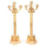 A PAIR OF FRENCH ORMOLU CANDLELARBRA with four branch tops having scrolled leaf work decoration,