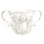 A QUEEN ANN SILVER PORRINGER the body flanked by S scroll handles, with fluted base and rope-twist