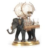 A 19TH CENTURY CONTINENTAL NOVELTY LACQUER SET formed as an Elephant holding a glass barrel and