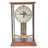AN EARLY 20TH CENTURY FRENCH BULLE ELECTRIC CLOCK the brass and mahogany four-glass case enclosing a
