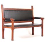A LATE 19TH CENTURY GOTHIC PUGIN STYLE OAK HALL BENCH with black leather upholstered seat, the frame