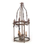 A LARGE EARLY 20TH CENTURY CIRCULAR BRASS HANGING LANTERN with shaped top supports and four branch