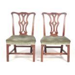 A PAIR OF GEORGE III MAHOGANY CHIPPENDALE STYLE SIDE CHAIRS with leaf carved open pierced backs