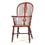 AN EARLY 19TH CENTURY HIGH BACK YEW WOOD WINDSOR ARMCHAIR having hooped back with pierced shaped