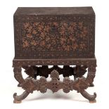 A 19TH CENTURY INDIAN LACQUERED CHEST ON STAND with hinged lid decorated gilt floral and leaf work