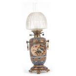 A LATE 19th CENTURY ROYAL DOULTON OIL LAMP WITH OVAL PANEL DECORATED BIRDS BY HANNAH BARLOW having a