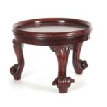 A WILLIAM IV MAHOGANY JARDINIERE STAND having a circular gallery top raised on three carved cabriole