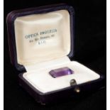 A 19TH CENTURY LARGE AMETHYST STONE with faceted sides, in an original leather case bearing a