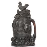 A LARGE 19TH CENTURY SWISS CARVED WOOD STEIN modelled as a barrel with grapevine handle, the