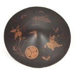 A JAPANESE MEIJI PERIOD LACQUERED PAPIER MACHE CEREMONIAL SHIELD decorated with gilt work flowers