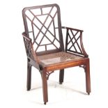 A GEORGE III MAHOGANY CHIPPENDALE STYLE COCKPEN ARMCHAIR with trellis work back and arms above a