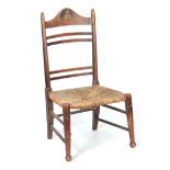 A LATE 19TH CENTURY LIBERTY STYLE OAK LADDER BACK CHILD'S CHAIR with rush seat and marquetry panel
