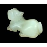 AN ORIENTAL CARVED WHITE JADE SCULPTURE OF A RECLINING DOG 7cm across 4.5cm high