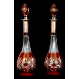 A LARGE PAIR OF BOHEMIAN AMBER FLASHED CUT GLASS DECANTERS AND STOPPERS with engine turned Silver