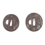 TWO JAPANESE MIXED METAL BRONZE TSUBA of oval form with cast relief figures by trees and rocks,