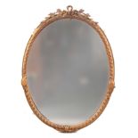 A LARGE 19TH CENTURY CARVED GILT GESSO OVAL HANGING MIRROR with moulded ribbon edge frame and floral