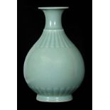 A CHINESE OVOID CELADON VASE with slender flared neck above a fan moulded relief work shoulder