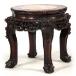 A 19TH CENTURY PROFUSELY CARVED CHINESE HARDWOOD CIRCULAR JARDINIERE STAND with marble inset top and