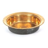 AN 18TH CENTURY BRASS CIRCULAR BOWL with flattened rim and ringed interior 38cm diameter 9cm high.