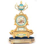 A LATE 19TH CENTURY FRENCH ORMOLU AND PORCELAIN PANELLED MANTEL CLOCK the case surmounted by a