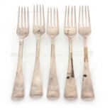 A SET OF FIVE GEORGE III IRISH SILVER TABLE FORKS with griffin and crown crests to the handles, 20cm