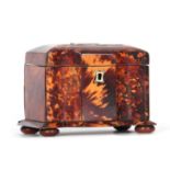 AN EARLY 19TH CENTURY TORTOISESHELL VENEERED TEA CADDY of serpentine fronted rectangular form with
