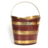 A GEORGE III OVAL MAHOGANY OYSTER / PLATE BUCKET of coopered form with folding brass handle and
