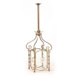 A 19TH CENTURY GILT BRASS HANGING HALL LANTERN with scrolled supports above ring turned side columns