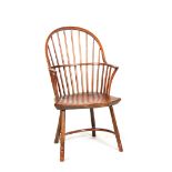 A 19TH CENTURY ASH AND ELM STICK BACK WINDSOR CHAIR with a hooped back and shaped seat; standing