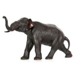 A JAPANESE MEIJI PERIOD PATINATED BRONZE SCULPTURE BY GENRYUSAI SEIYA modelled as a walking elephant