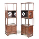 A PAIR OF EARLY 20th CENTURY CHINESE ASH STAINED WHATNOTS having two tiers joined by fret cut panels