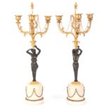 A FINE PAIR OF REGENCY BRONZE AND ORMOLU THREE BRANCH CANDLEARBRA with leaf cast stems and lyre-