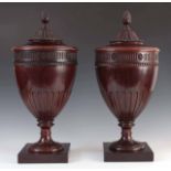 A PAIR OF EDWARDIAN ADAM STYLE URN SHAPED CUTLERY STANDS the lift-off carved tops with pineapple