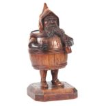 A LATE 19TH CENTURY BLACK FOREST CARVED TOBACCO JAR modelled as a gnome in a barrel standing on a