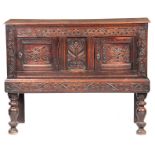 A 17TH CENTURY CARVED OAK SIDE CUPBOARD / BUFFET having superb original colour and patina, the plank