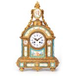 A LATE 19TH CENTURY ORMOLU AND SERVES PANEL MANTEL CLOCK the case surmounted by an oval miniature of