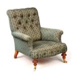 A 19TH CENTURY HOWARD STYLE BUTTON UPHOLSTERED ARMCHAIR with walnut turned legs and sweeping back