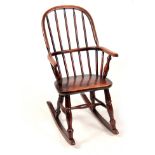 AN EARLY 19TH CENTURY ASH AND ELM CHILD'S CHAIR with hooped back, saddle seat and turned legs
