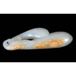 A CHINESE WHITE JADE CARVED SCULPTURE modelled as two plums with russet edge 9cm overall