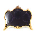 A 19TH CENTURY FRENCH ORMOLU MINIATURE PORTRAIT HOLDER of rococo design with leaf moulded corners