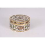 A JAPANESE CLOISONNE ENAMEL CIRCULAR BOX AND COVER decorated with leaf work and flower heads 9.5cm