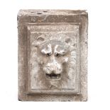 A 19TH CENTURY CARVED STONE LION'S FACE MASK of a male beast 30cm wide 38cm high.