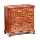 A GOOD QUEEN ANNE FIGURED WALNUT BACHELOR'S CHEST the hinged fold over top with dimpled corners
