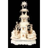 A 19TH CENTURY CHINESE CARVED IVORY MODEL OF A PALACE extravagantly carved with a central three-tier