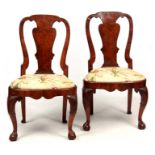 A PAIR OF GEORGE I WALNUT SIDE CHAIRS with shaped backs and drop-in seats; raised on cabriole legs