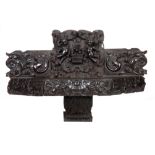 AN EARLY 17TH CENTURY CARVED OAK PRIVATE ALTAR with raised relief work carved back of cherubs