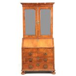 AN EARLY 18TH CENTURY HERRINGBANDED FIGURED WALNUT BUREAU BOOKCASE the shelved upper part with