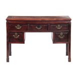 AN 18TH CENTURY HARDWOOD CHINESE DESK with panelled top above a moulded front fitted with five